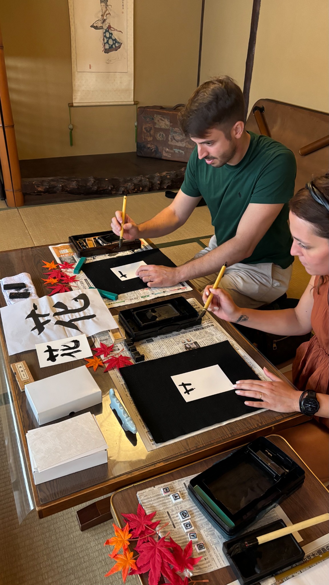 Guest practicing Japanese calligraphy