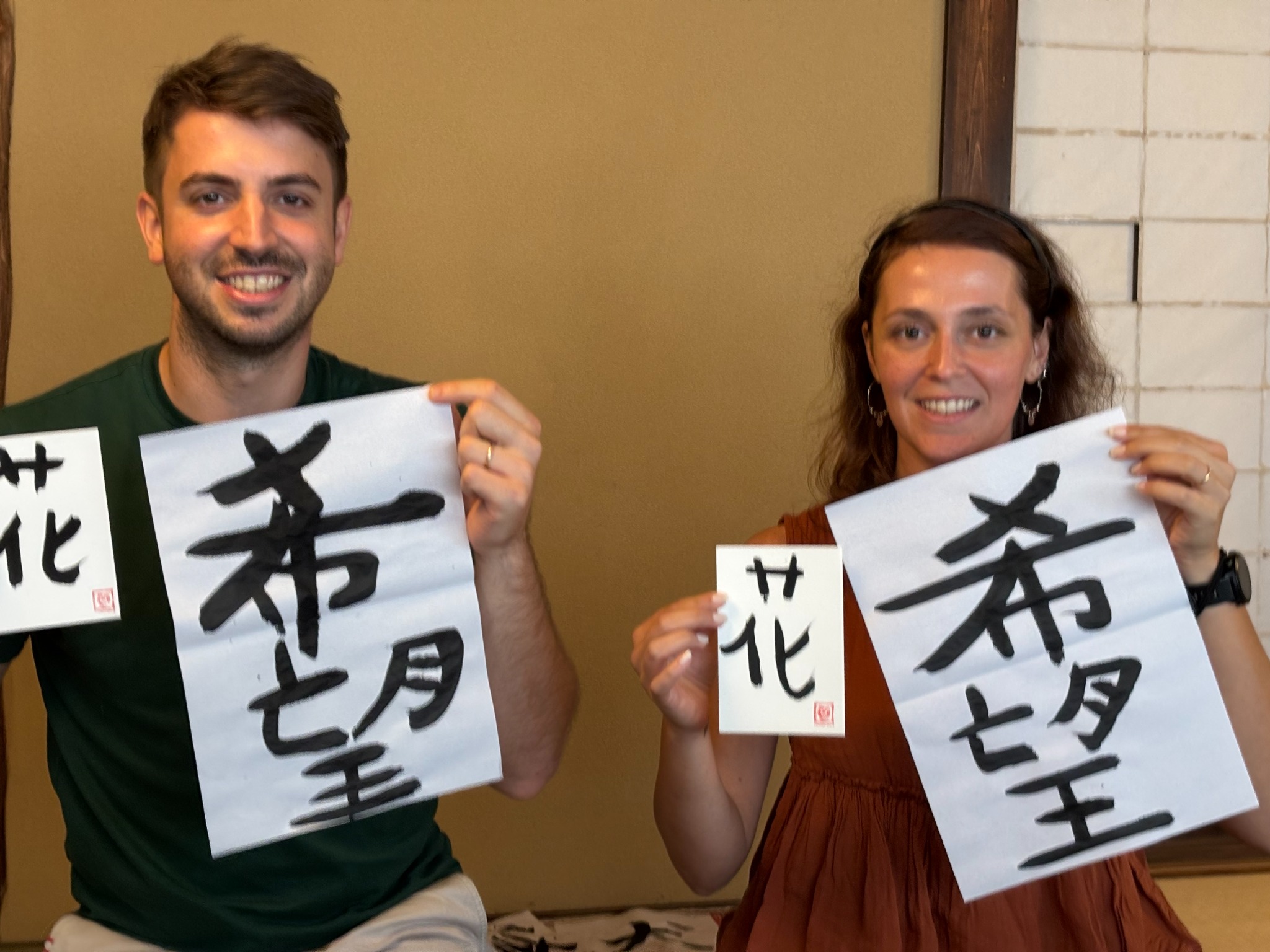 Guests holding their finished calligraphy