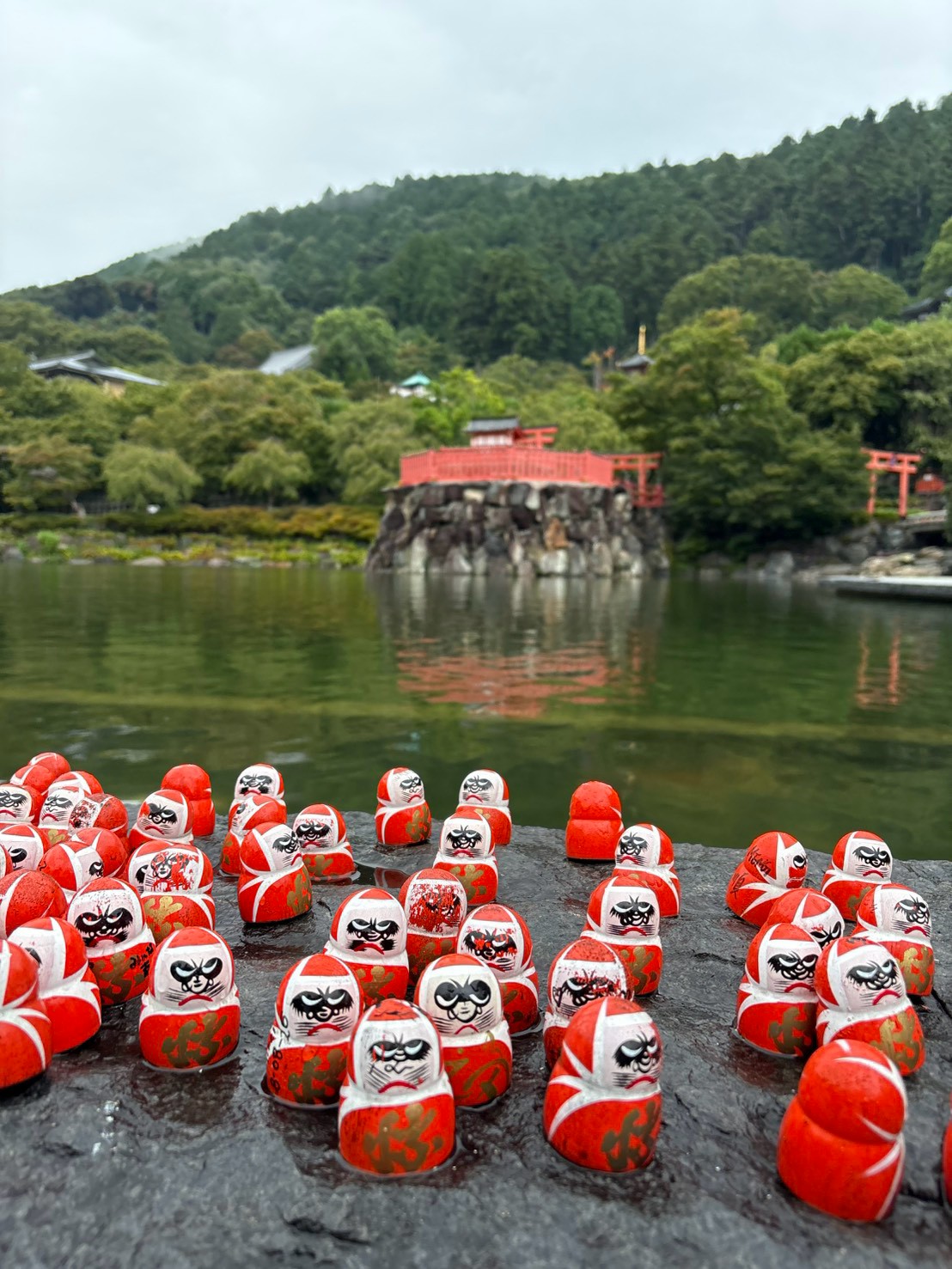 Daruma dolls and a pond at Katsuoji Temple