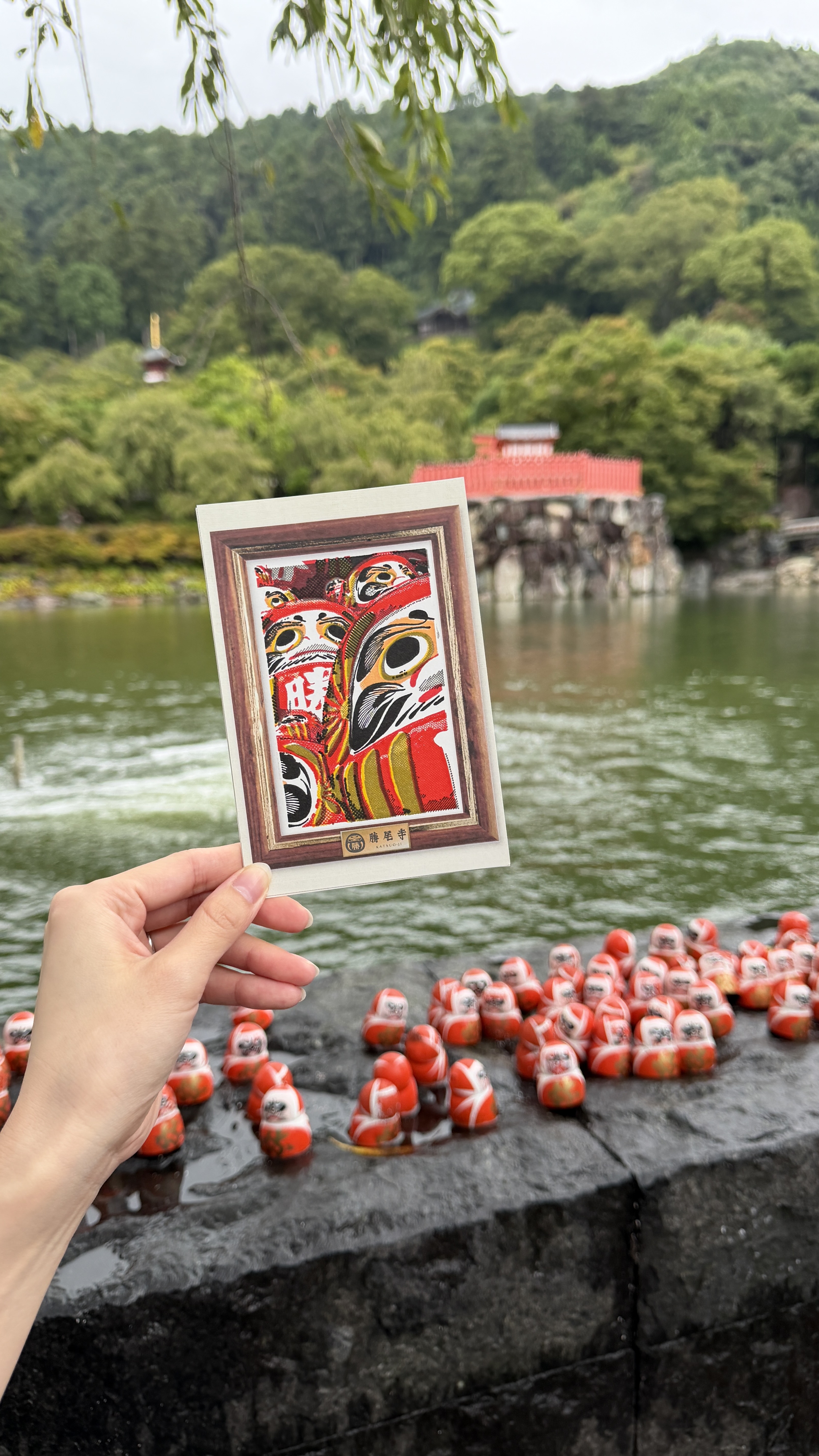 Katsuoji pond, daruma doll, and postcard